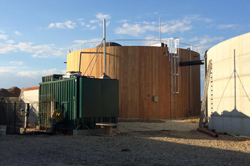 Bert biogas tank with wood cladding on a farm